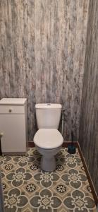 a bathroom with a toilet and a tile floor at Ma petite maison in Vierzon +17 photos