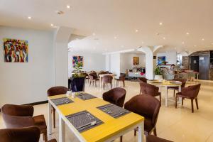 a restaurant with tables and chairs in a room at Jalo Hotel - Shashemene in Shashemenē
