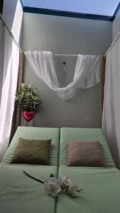 a green bed in a room with a window at El Nido wellness a spa in Vysoké Mýto +13 photos