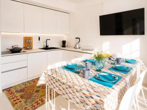 a kitchen with a table with blue dishes on it at Sunrise Apartment by Symphonya Luxury Holiday Rentals in Otranto