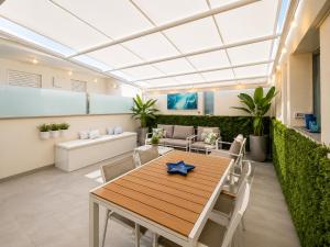 a dining room with a table and chairs at Sunrise Apartment by Symphonya Luxury Holiday Rentals in Otranto