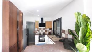 a kitchen with a refrigerator and a stove at Fantastic appartement in Hammam Sousse