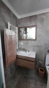 a bathroom with a sink and a mirror at Fantastic appartement in Hammam Sousse +1 photo