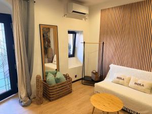 a living room with a couch and a mirror at Studio LA PETITE PAUSE in Ajaccio