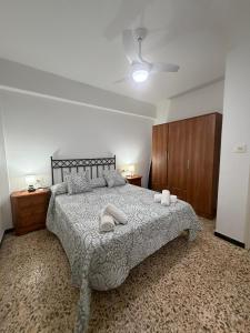 a bedroom with a bed with two towels on it at Hospederia Ortiz 2 in Níjar