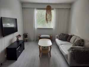 a living room with a couch and a table at Gran Palmu in Pori