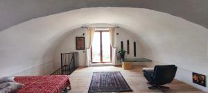 a bedroom with a bed and a desk in a room at Guesthouse Acherusia in Bacoli