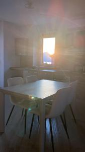 a table and chairs in a kitchen with a window at Around Lago Maggiore apartments in Reno Di Leggiuno