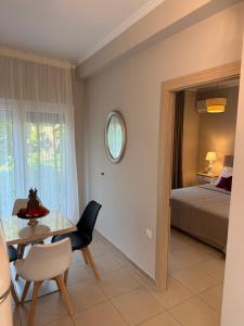 a dining room with a table and a bedroom at Marinas view apartment in Limenas