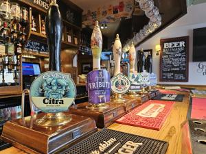 a bar with several bottles of alcohol on a counter at The Waggon & Horses in York