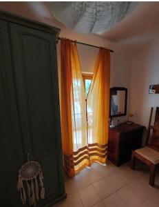 a room with a window with curtains and a table at Da Ross in Castel di Sangro