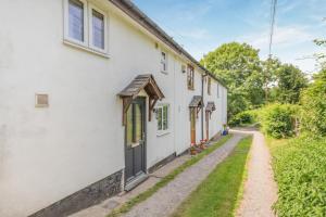 a white house with a path leading up to it at 2 Bed in Richards Castle oc-r45225 in Lane to Richards Castle