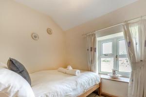 a bedroom with a white bed and a window at 2 Bed in Richards Castle oc-r45225 in Lane to Richards Castle