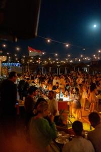 a crowd of people at a party at night at Alaçatı Beach Resort in Yumru +211 photos
