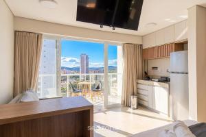 a kitchen with a large window with a view at Modern studio in a condominium with pool MSU0701 in Governador Valadares