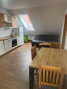 a kitchen and living room with a table and chairs at Apartmán Netolice in Netolice