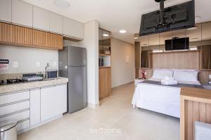 a kitchen and a bedroom with a bed in a room at Modern studio in a condominium with pool MSU0701 in Governador Valadares