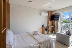 a bedroom with a bed and a couch and a tv at Studio in a cond. w/gym in the city center MSU0301 in Governador Valadares