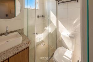 a bathroom with a shower and a toilet and a sink at Studio in a cond. w/gym in the city center MSU0301 in Governador Valadares