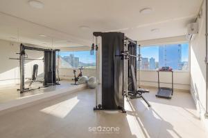 a room with a gym with a large window at Studio in a cond. w/gym in the city center MSU0301 in Governador Valadares