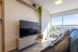a living room with a large flat screen tv at Apto w/ A/C in Anápolis Downtown GRLB1802 in Anápolis