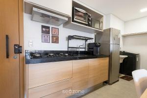 a kitchen with a sink and a stove at Apto w/ A/C in Anápolis Downtown GRLB1802 in Anápolis