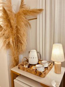 a tea kettle and bowls on a tray on a table at Hotel Ibicui in Rosário do Sul +24 photos
