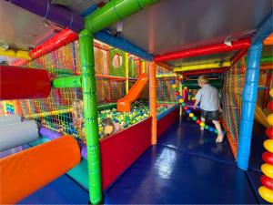 a man and a child playing in an indoor play gym at Domki Ania in Łeba