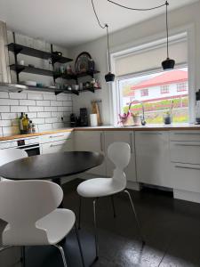 a kitchen with a table and chairs and a window at G6 Apartment in Grundarfjordur