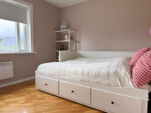 a white bed in a bedroom with a window at G6 Apartment in Grundarfjordur