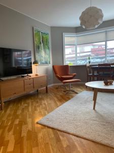 a living room with a tv and a table at G6 Apartment in Grundarfjordur