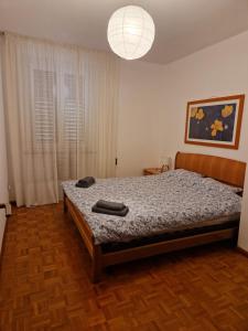 a bedroom with a bed and a lamp at Lakeview apartment in Pergine Valsugana