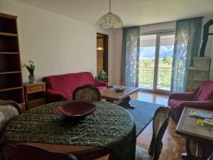 a living room with a table and chairs at Lakeview apartment in Pergine Valsugana