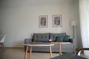 a living room with a couch and a coffee table at Meltemi by GG in Alexandroupoli +20 photos