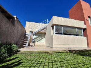 a building with a staircase in front of it at Dos Lapachos in San Fernando del Valle de Catamarca