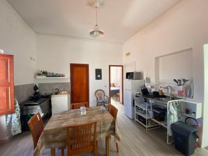 a kitchen with a table and chairs in a room at Ecoflat Casa Vacanze in Lipari