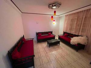 an aerial view of a living room with red furniture at Vacation home in Kelibia +2 photos