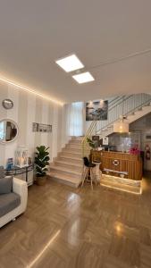 a living room with a staircase and a couch at B&B - Meuble' - Hotel " CORDIALE " in Misano Adriatico