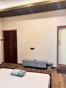 a room with two beds and a mirror at Rodali stay in Dibrugarh +2 photos