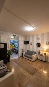 a large living room with a couch and a tv at B&B - Meuble' - Hotel " CORDIALE " in Misano Adriatico