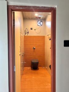 a bathroom with a toilet and a shower at Rodali stay in Dibrugarh
