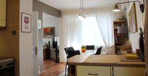 a kitchen and living room with a table and chairs at Sunny Day Apartment in Pomorie
