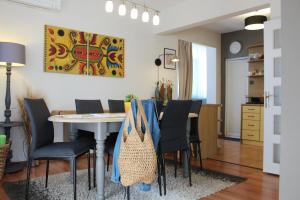 a dining room and living room with a table and chairs at Sunny Day Apartment in Pomorie