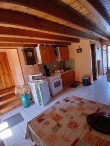 a large kitchen with white appliances in a room at gite du coin in Cunlhat