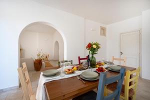 a dining room with a wooden table and chairs at Oltre i coni in Santa Lucia