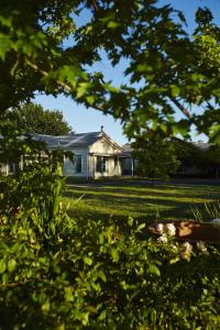 a white house in the middle of a yard at Grampians View B&B in Dunkeld