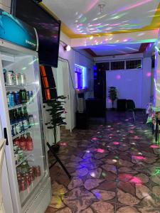 a room with a refrigerator with lights in it at BAYO-HOTEl in Vaudreuil