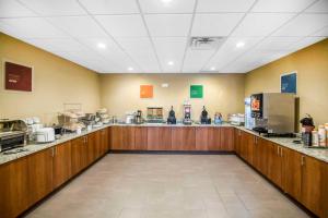 a large room with a food counter in a restaurant at Comfort Suites - Dodge City in Dodge City