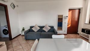 a living room with a couch and a table at JENNAH House in Bussero +7 photos