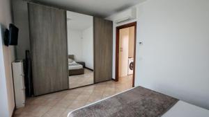 a large mirror in a room with a bedroom at JENNAH House in Bussero